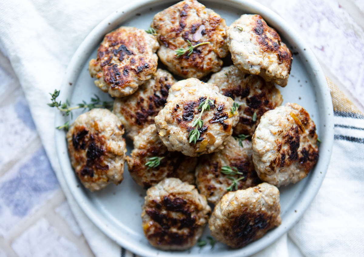 fresh cooked sausage patties in air fryer on a plate