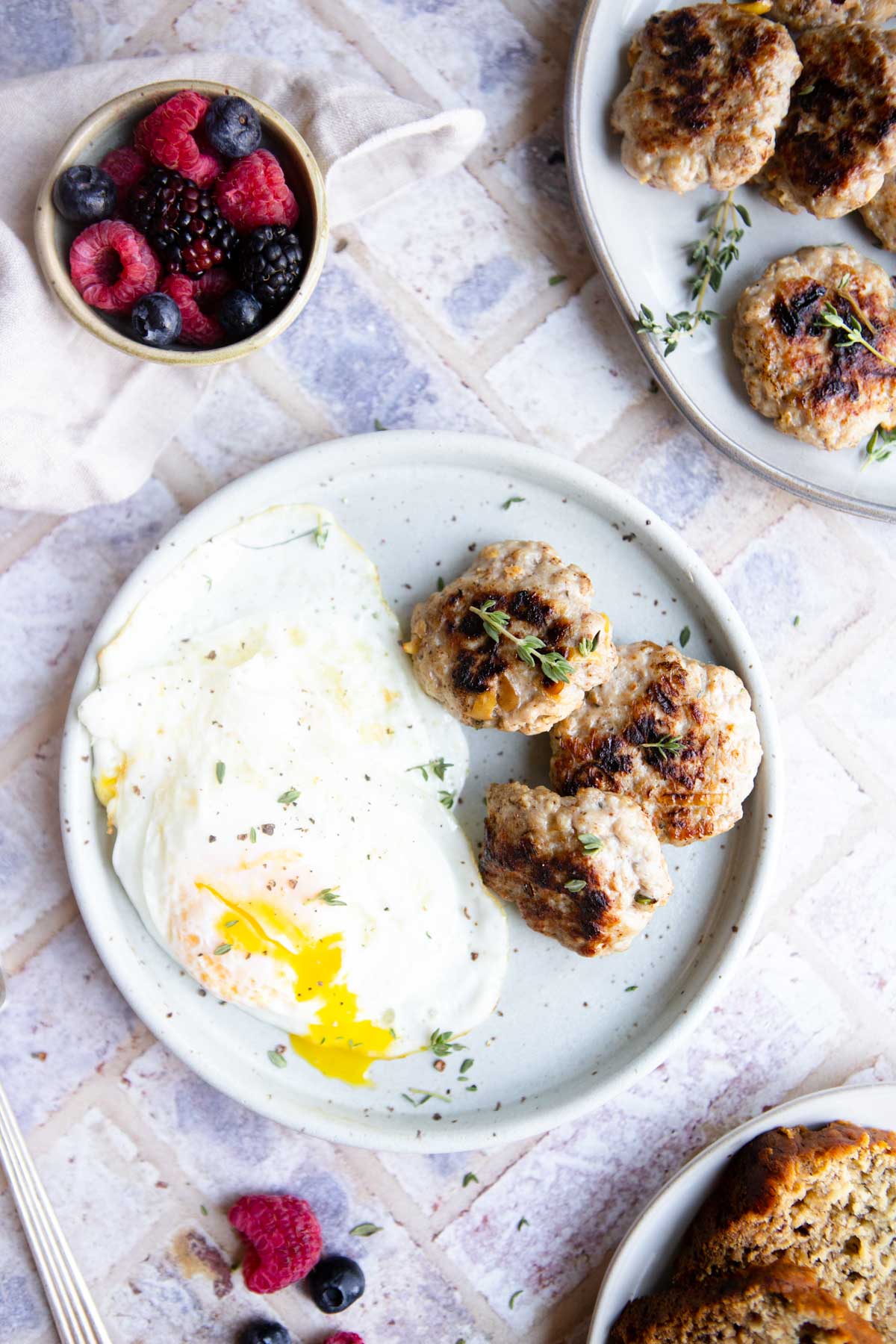 air fryer sausage patties served next to over easy eggs on a plate