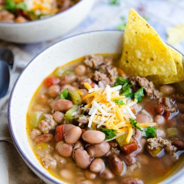 pinto bean soup cooked in the pressure cooker in a beige bowl