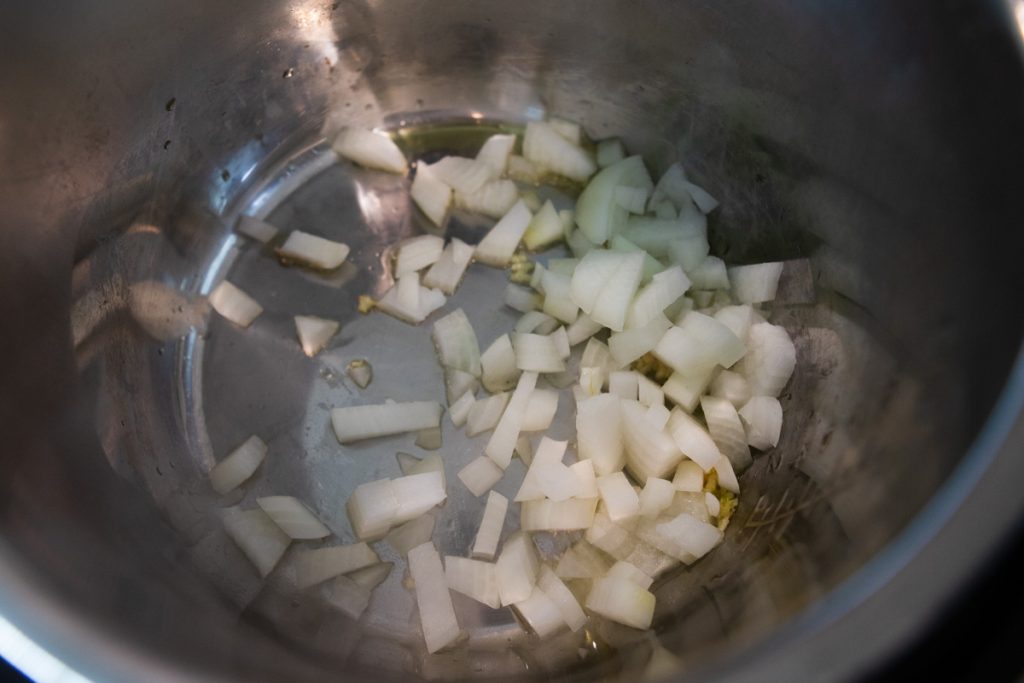 onions and garlic sauteing in the Instant Pot