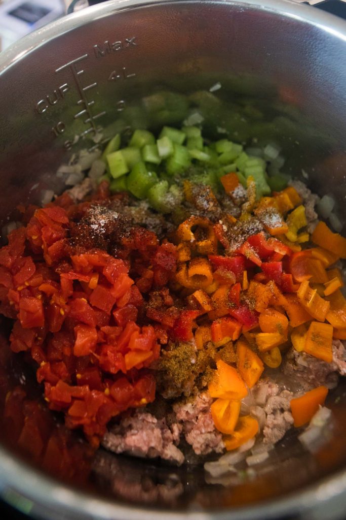 canned tomatoes, veggies, seasonings and ground turkey in the Instant Pot 