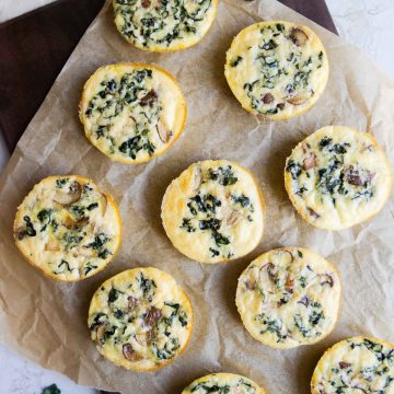 kale and mushroom egg bites on a wood platter