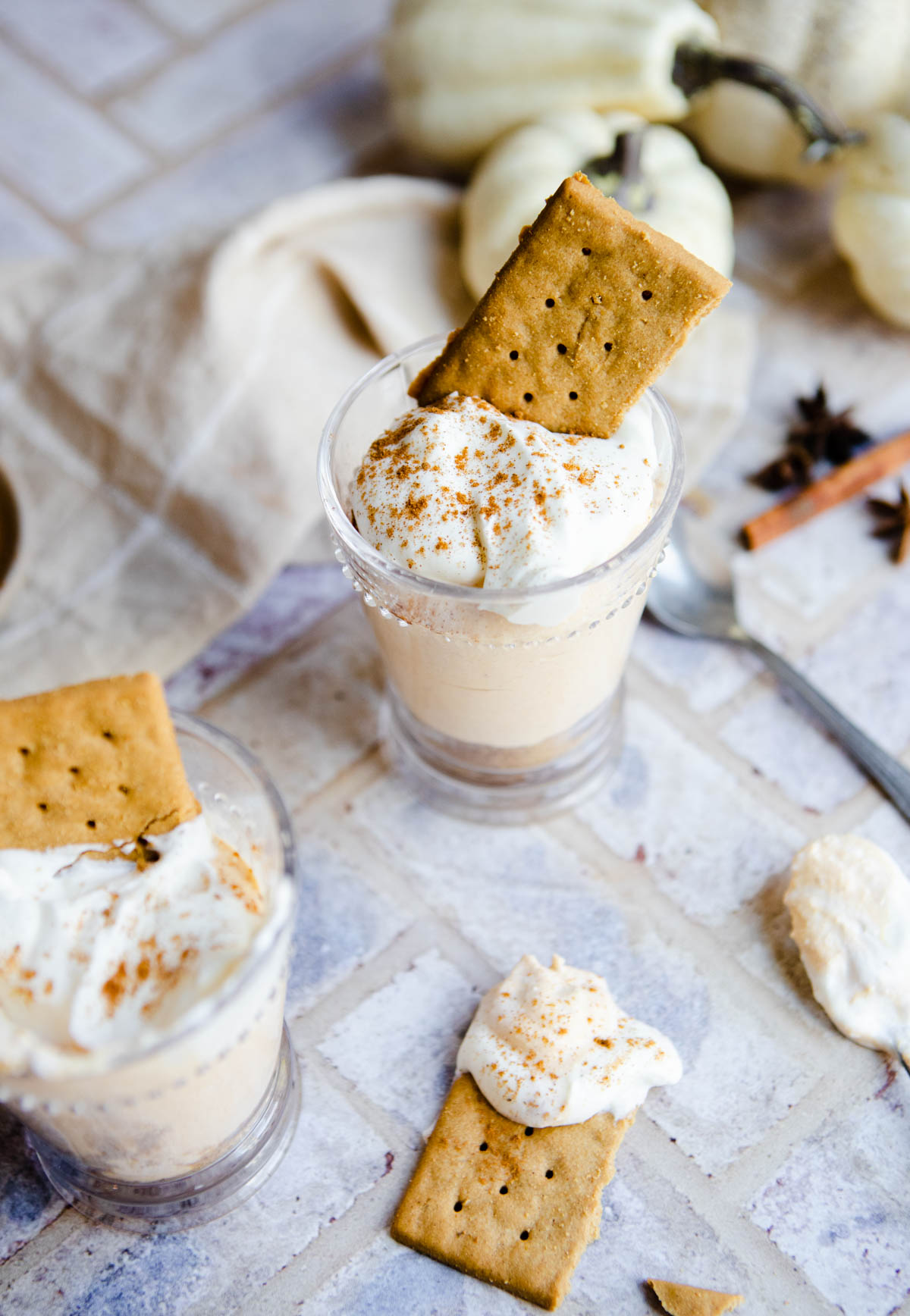 2 jars filled with pumpkin fluff and sprinkled with pumpkin pie spice