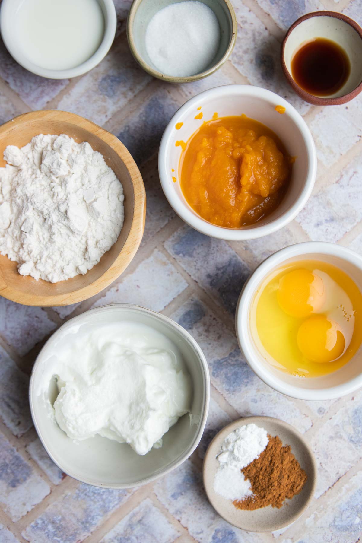 raw ingredients in small bowls to make pumpkin protein pancakes 