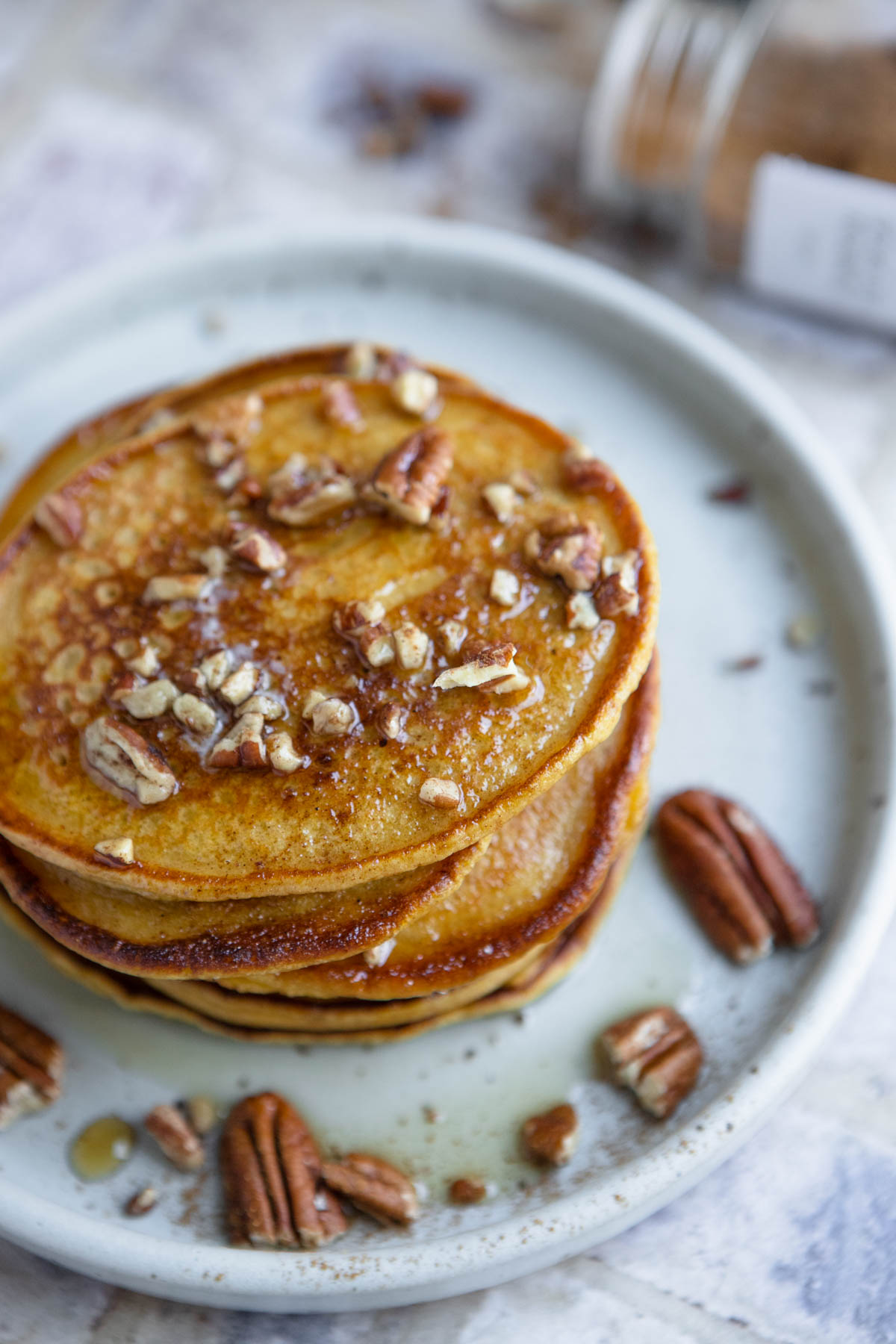 pumpkin pancakes slathered with warm maple syrup and topped with crunchy pecans 