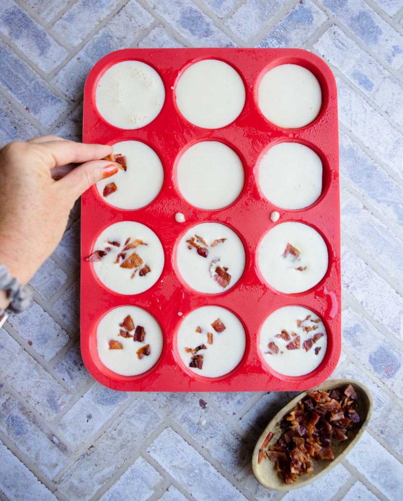 crispy bacon being added to egg bites 