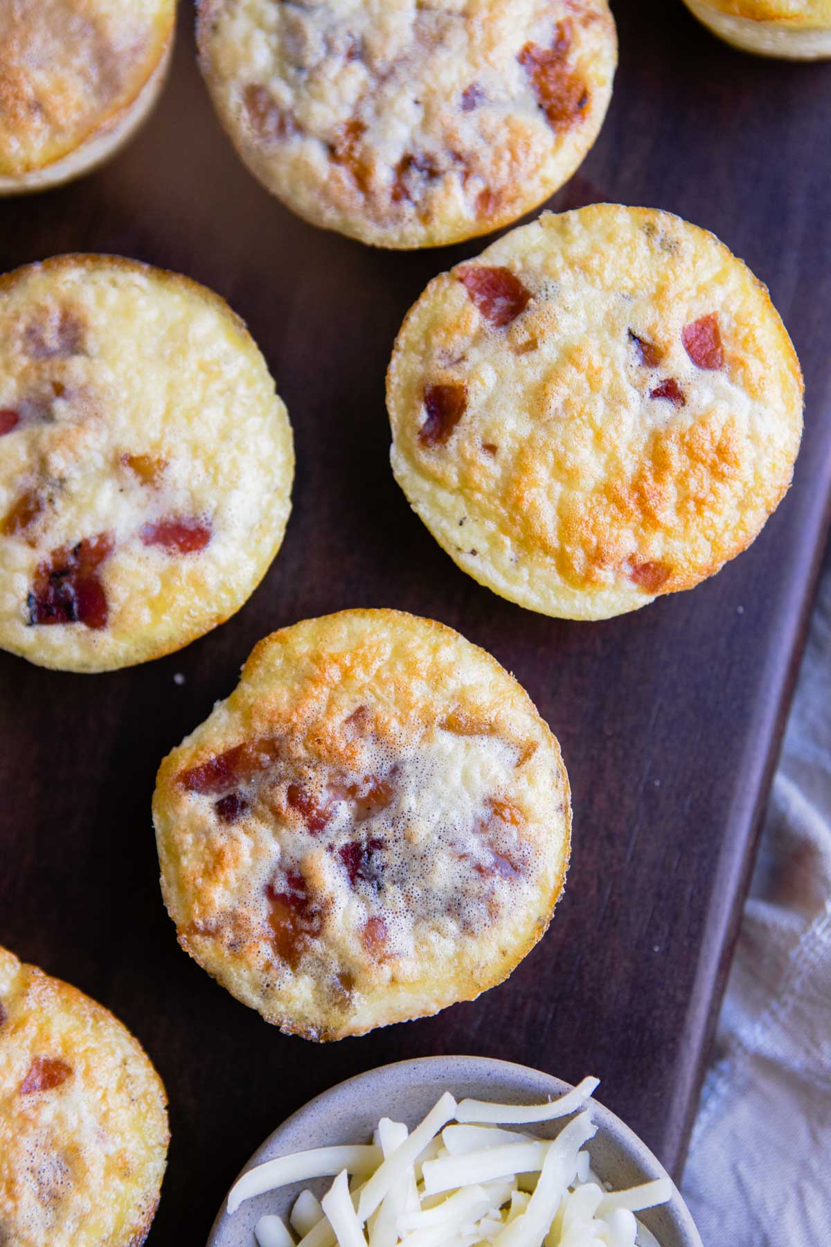 gruyere and bacon egg bites on a wooden board