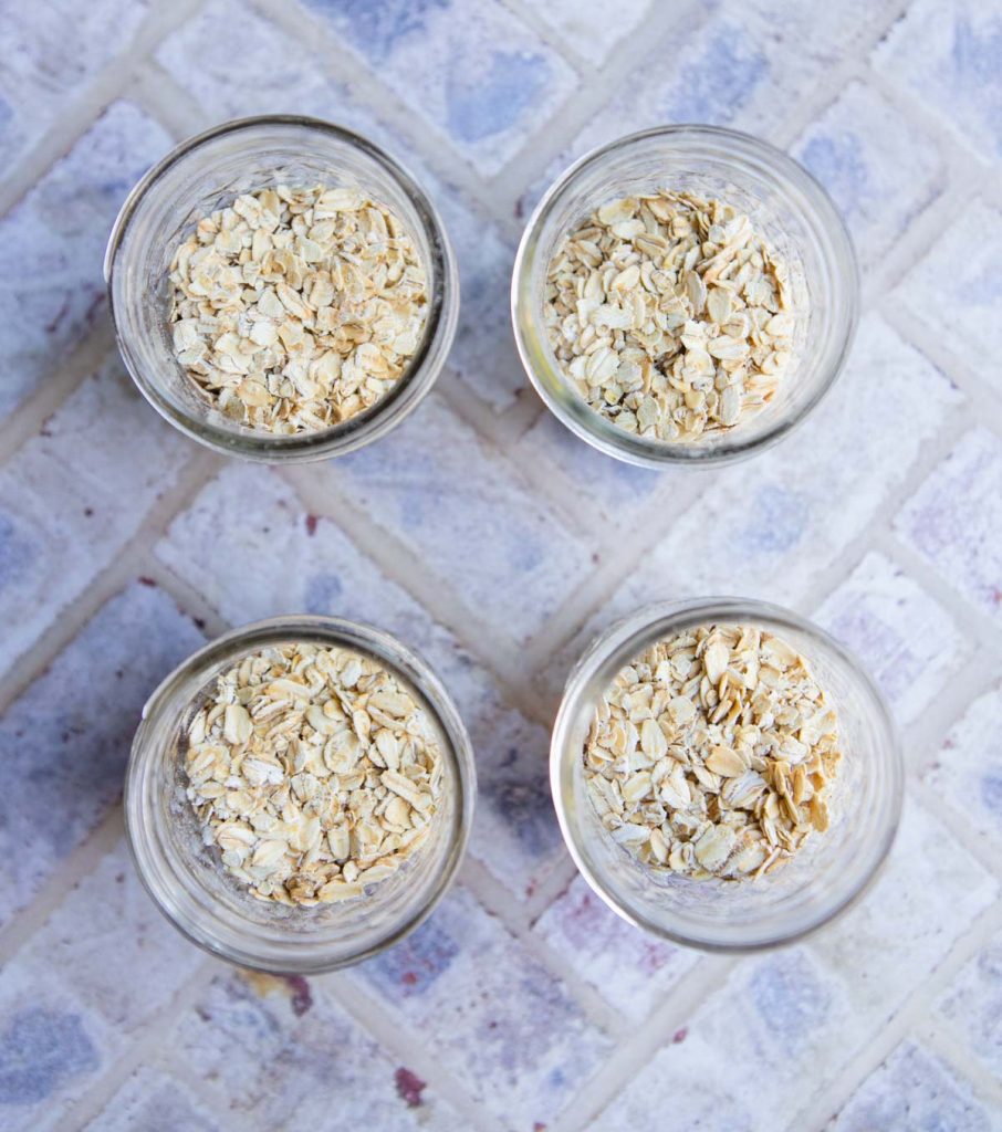 4 small mason jars filled with oats 