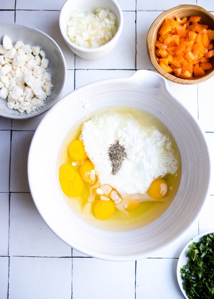 cottage cheese, eggs and egg whites added to a large bowl with salt and pepper
