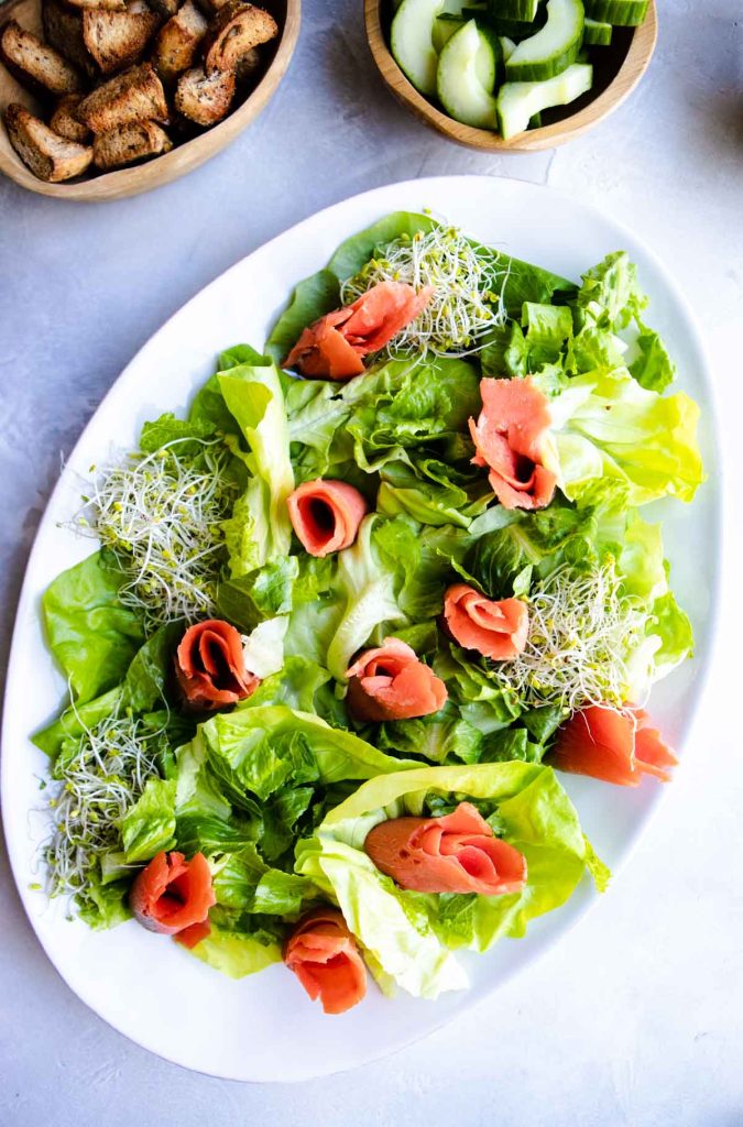butter lettuce with smoked salmon and sprouts set on top of it