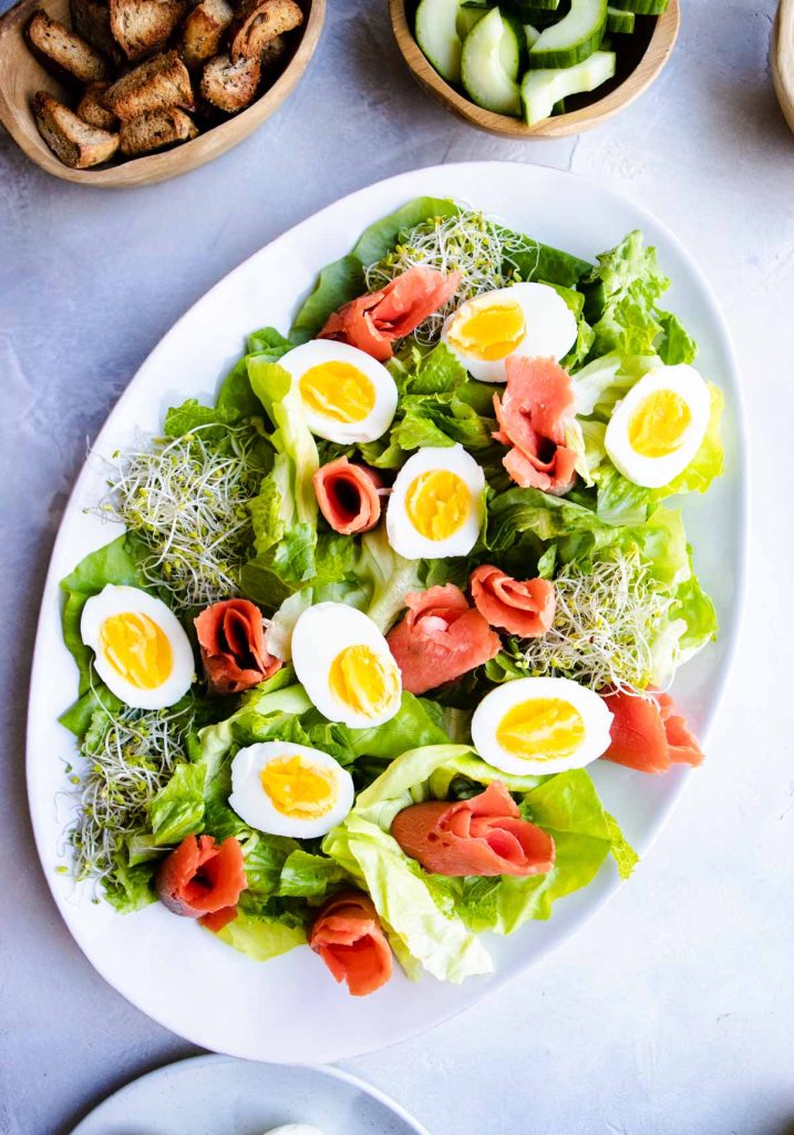 salad greens with soft-boiled eggs, sprouts and smoked salmon