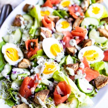 smoked salmon breakfast salad ready to be served on a platter