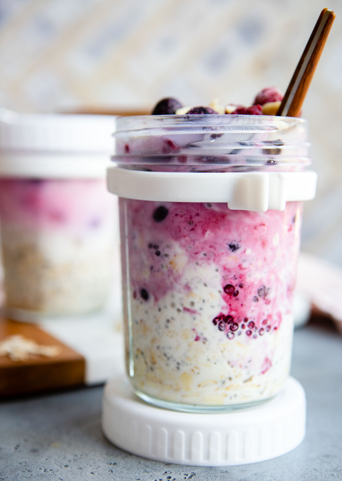 high protein overnight oats with Greek yogurt and frozen fruit in a glass jar