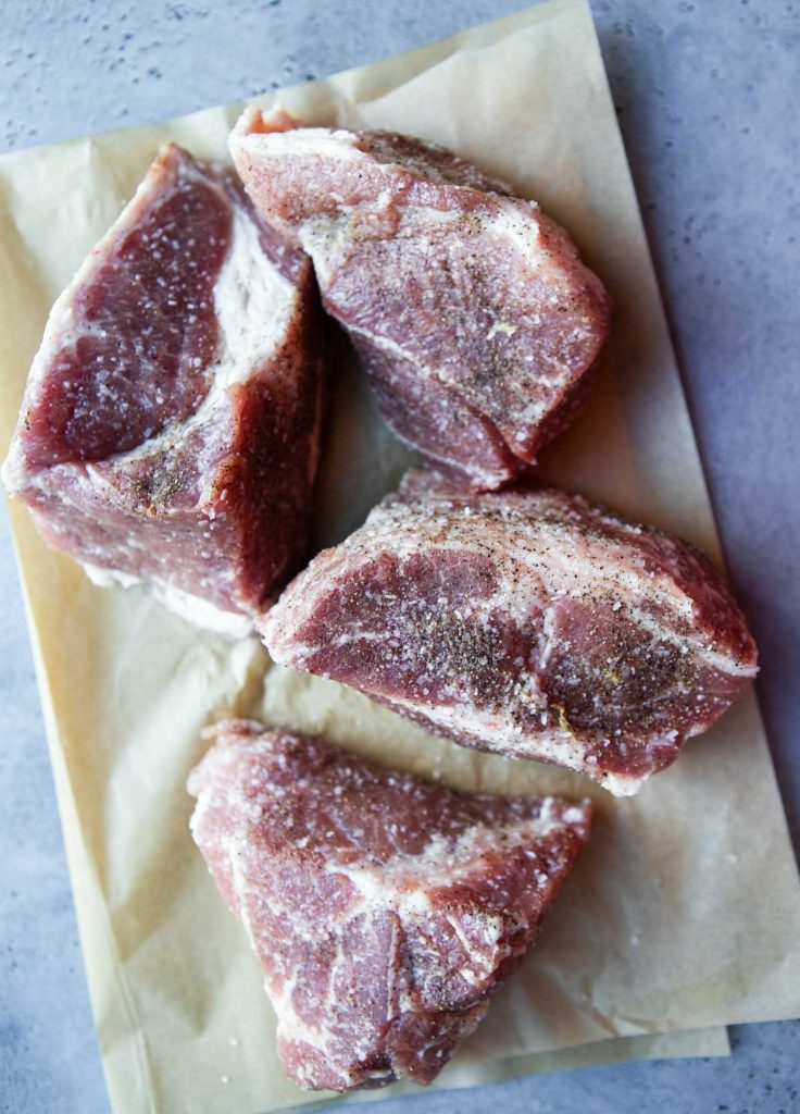 cuts of pork shoulder seasoned with salt and black pepper