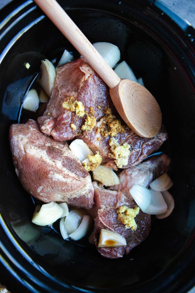 pork, onions, ginger and garlic in coconut water in a slow cooker