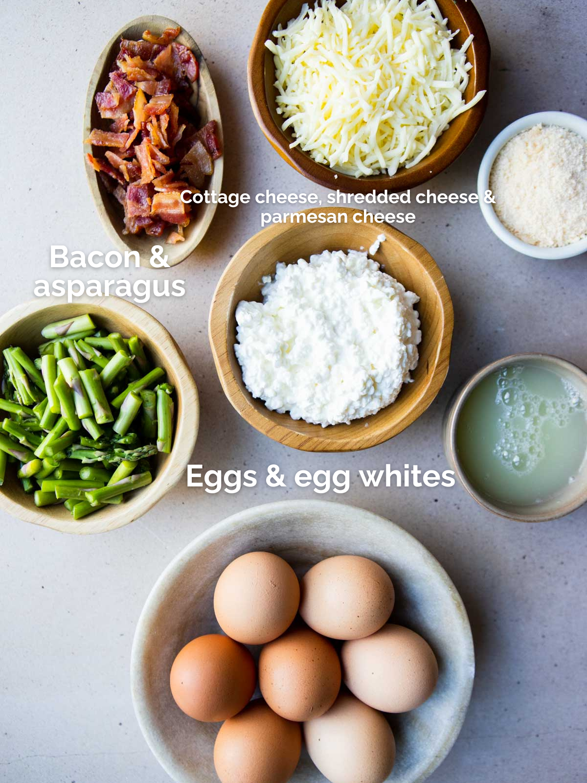 ingredients to make baked eggs and asparagus in small bowls