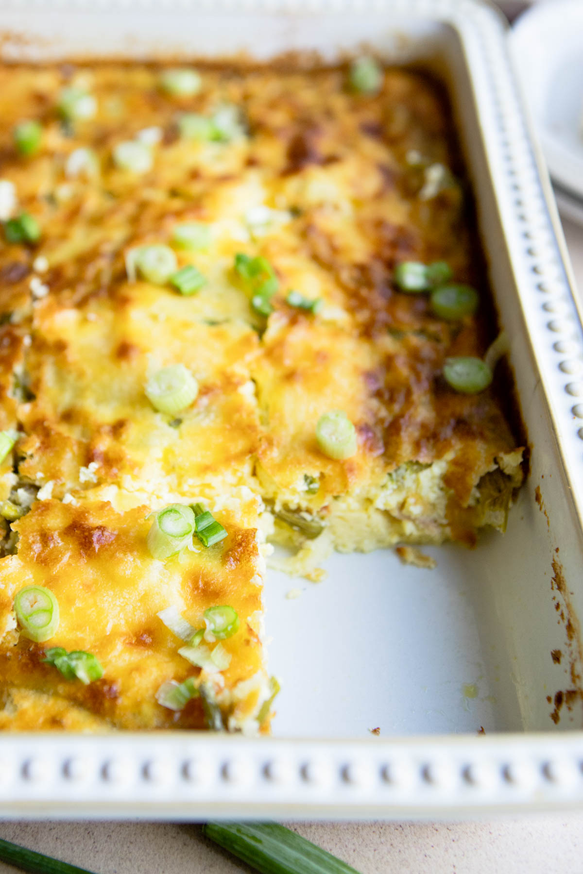 baked egg casserole in a white ceramic dish 