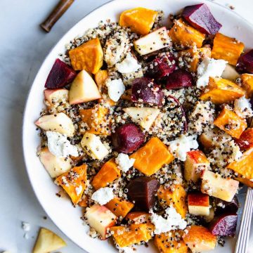 close up of a beet and quinoa salad served in a wide white bowl