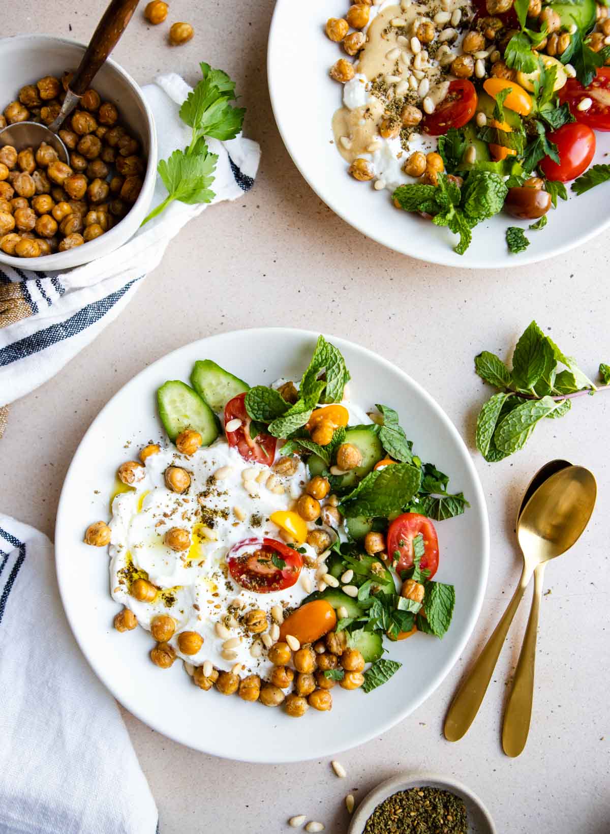 2 bowls filled with Greek yogurt and topped with veggies 