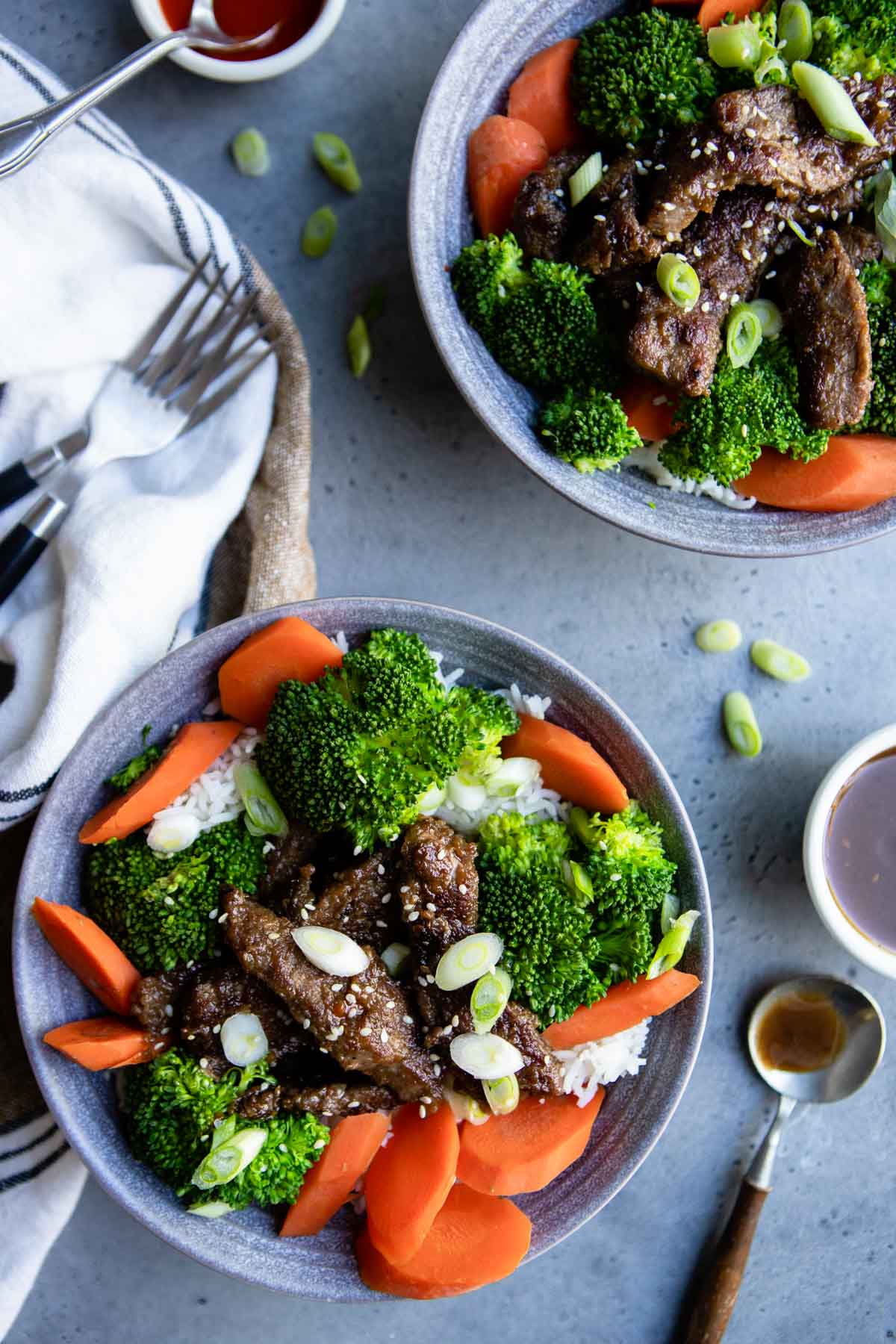 beef teriyaki bowls garnished with green onions and sesame seeds