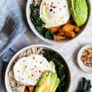 sweet potato breakfast bowls topped with over easy eggs and avocado