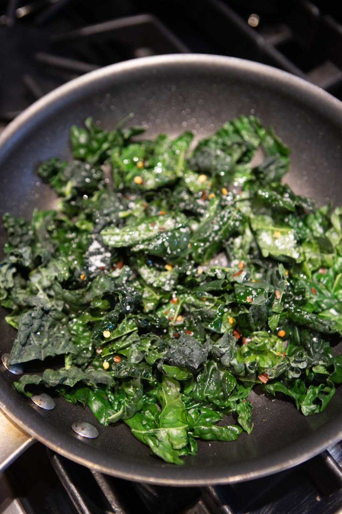 kale sauteing in a skillet