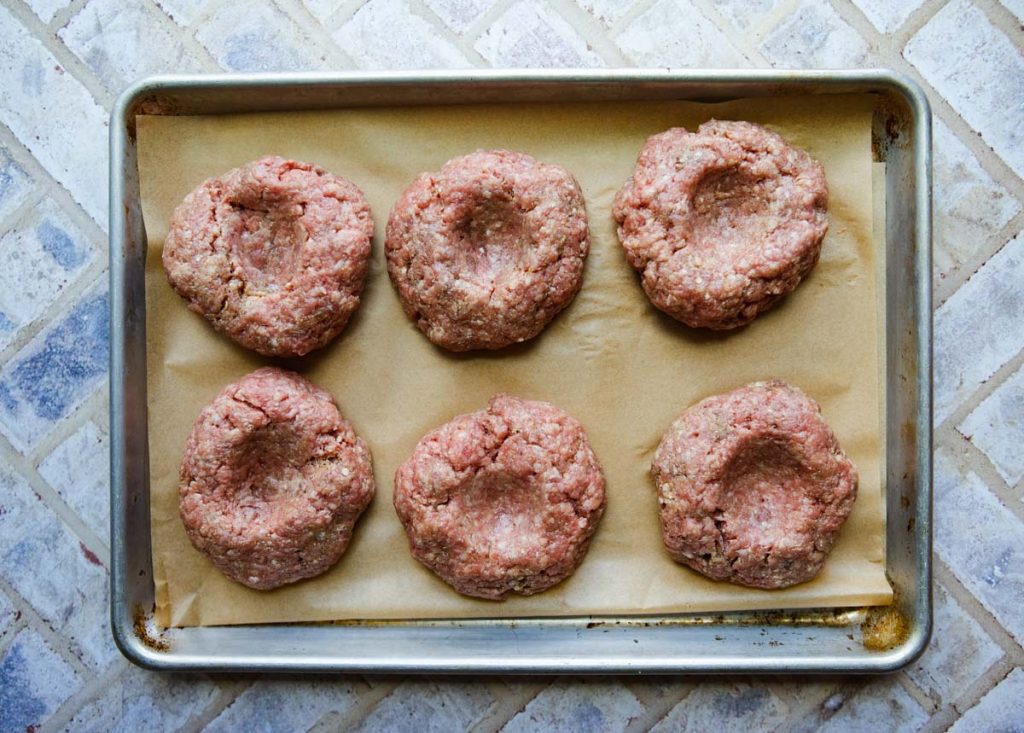 burger patties formed with an indentation in the middle