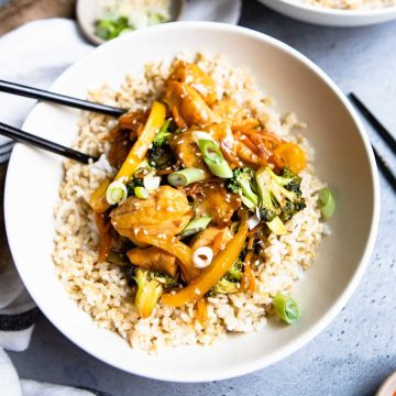 white bowl filled with chicken teriyaki and vegetables and brown rice