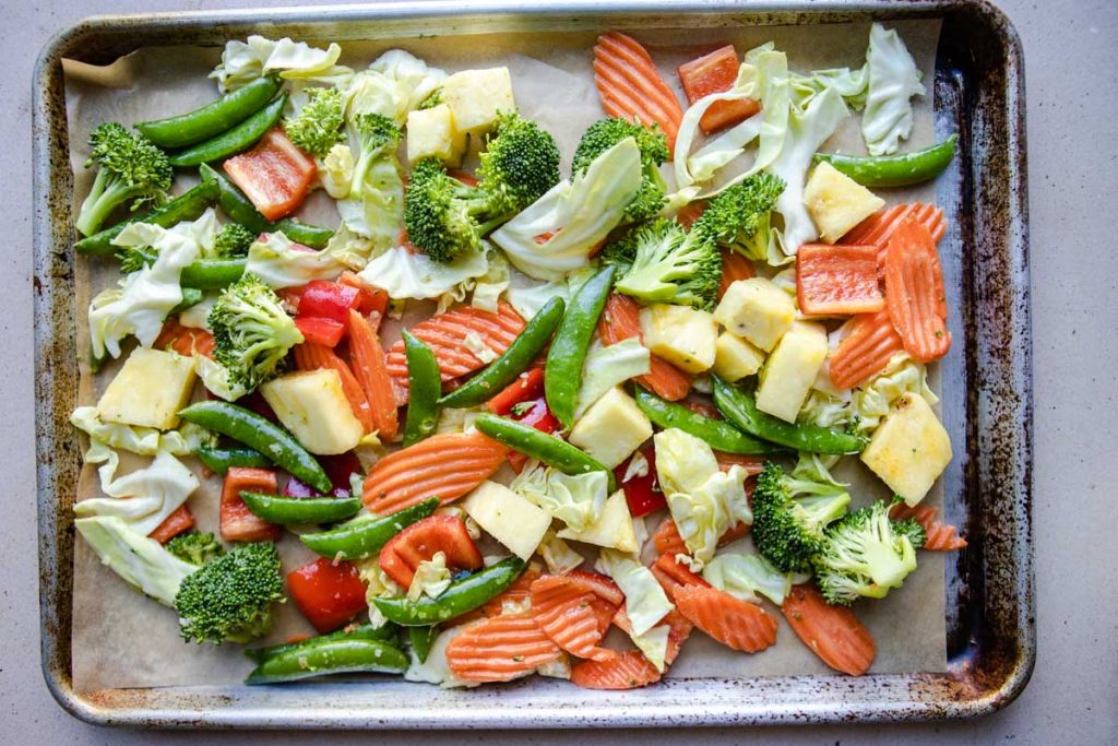 raw veggies tossed in olive oil and spread out on a sheet pan