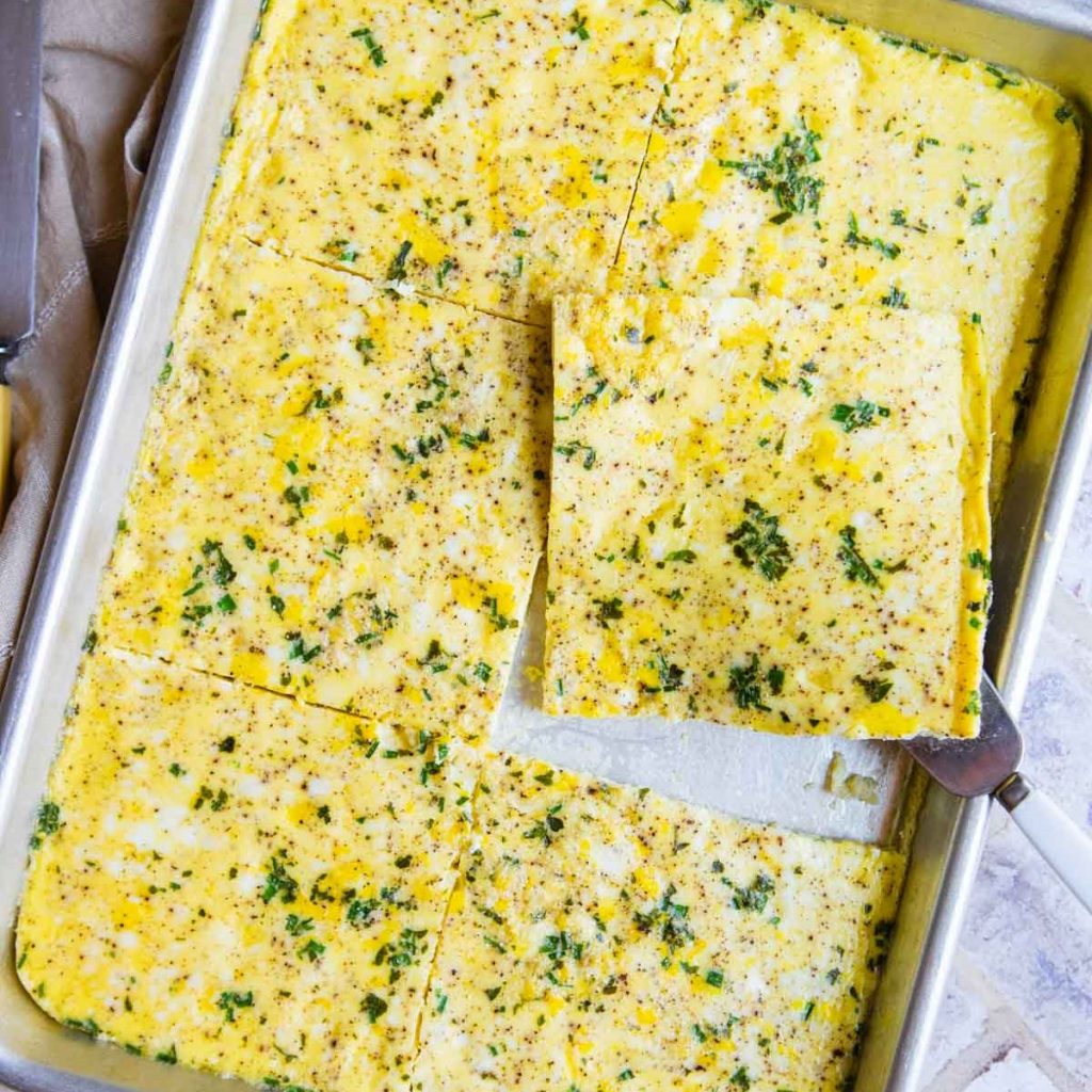 a quarter sheet pan filled with scrambled baked eggs
