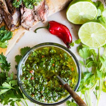 a small bowl filled with fresh cilantro chimichurri sauce