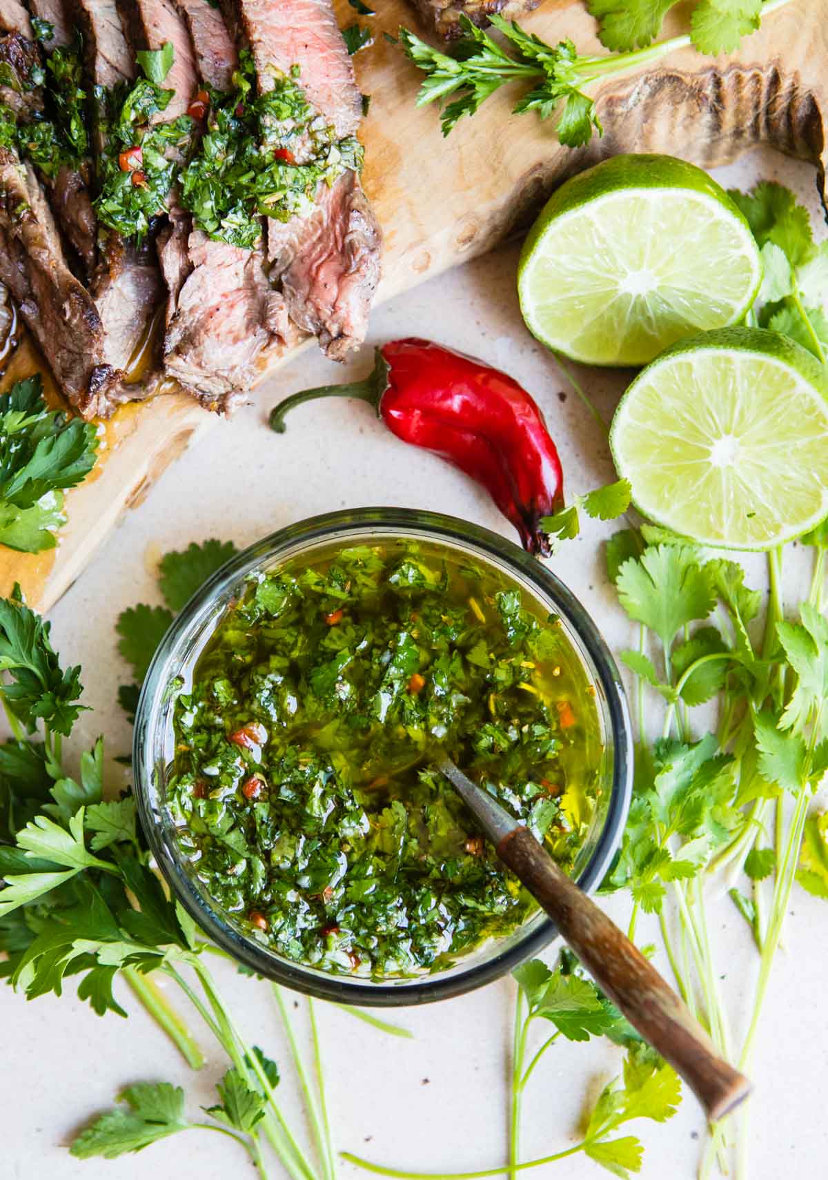a small bowl filled with fresh cilantro chimichurri sauce