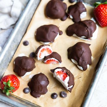 frozen chocolate strawberries on a parchment lined baking sheet