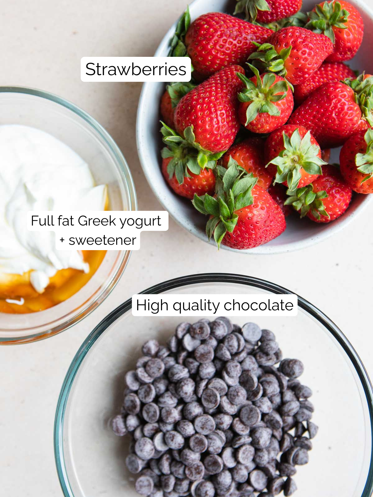 fresh strawberries, greek yogurt and couverture chocolate in small glass bowls