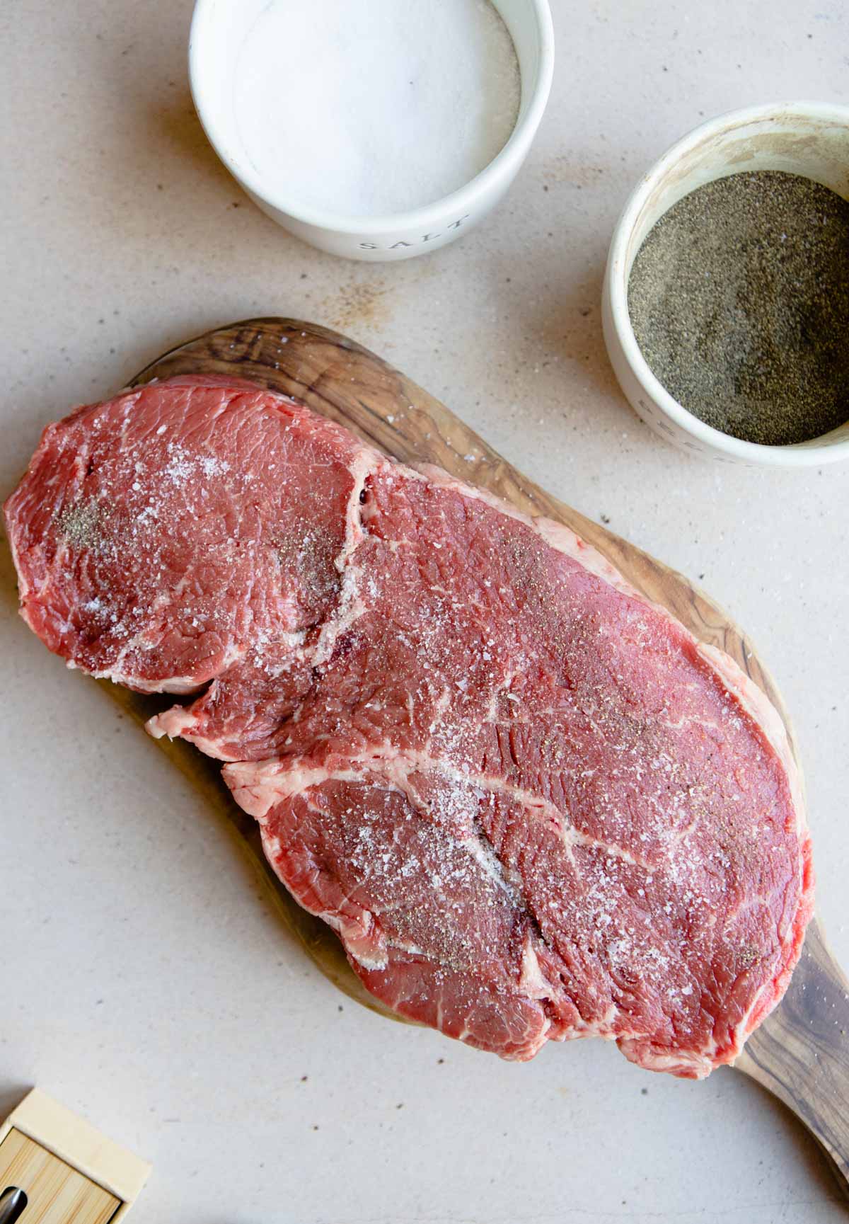 top sirloin steak seasoned with kosher salt and black pepper