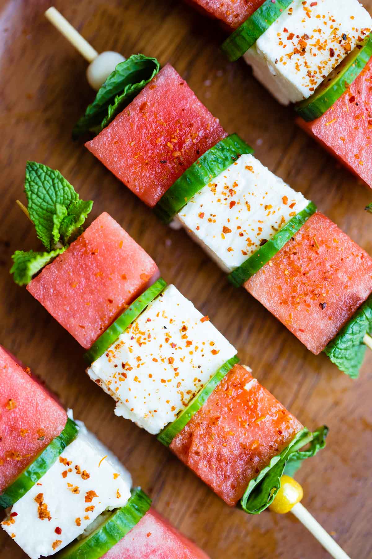 watermelon feta skewers garnished with mint and sprinkled with Tajin