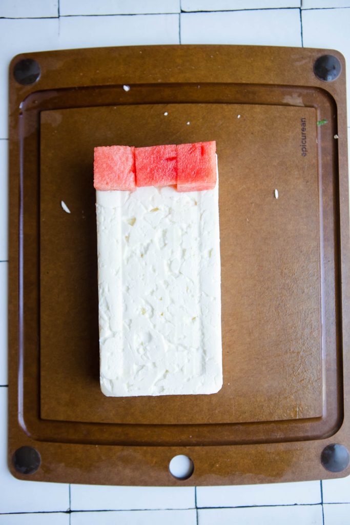 a block of reduced fat feta cheese ready to be cubed