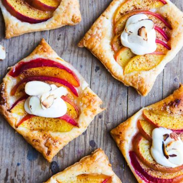 peach puff pastry tarts garnished with a light sour cream topping and slivered almonds