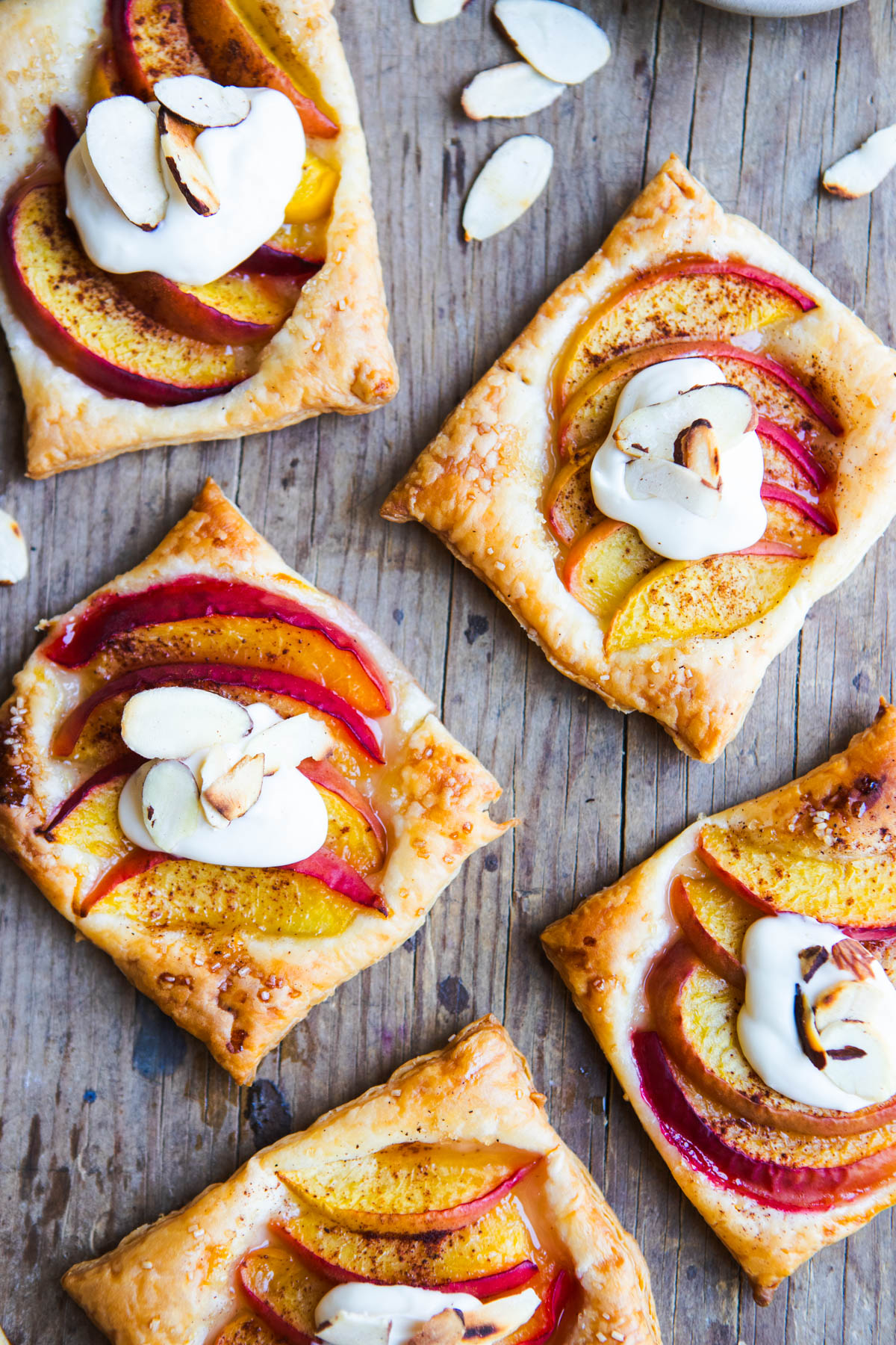 peach puff pastry tarts topped with fresh peaches and a sweet sour cream topping