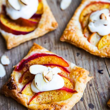 peach tarts topped with cream cheese topping and slivered almonds