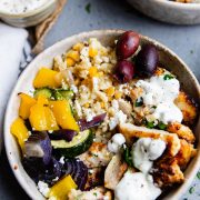 pearl couscous and grilled Mediterranean chicken with roasted vegetables in a ceramic bowl