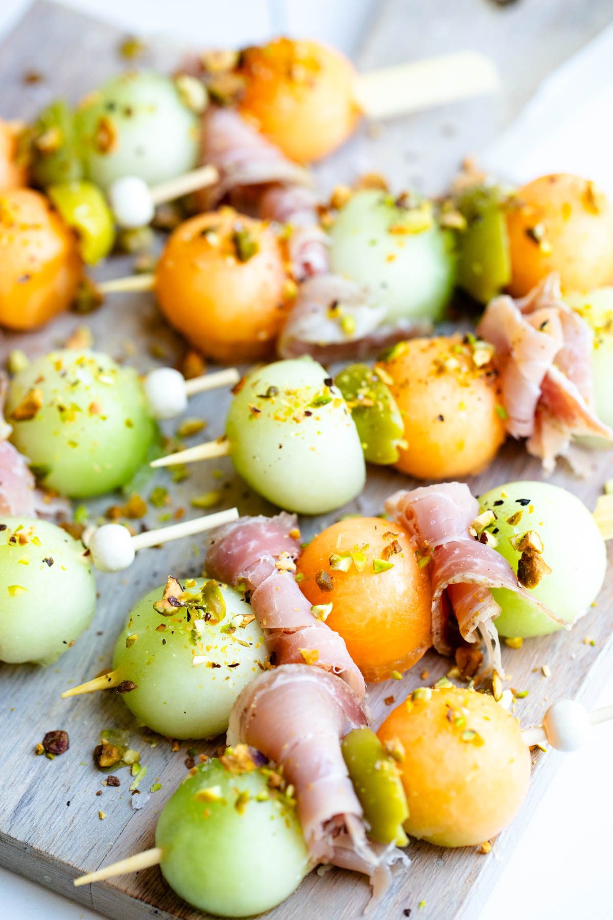 bamboo toothpicks with melon balls and prosciutto slices 