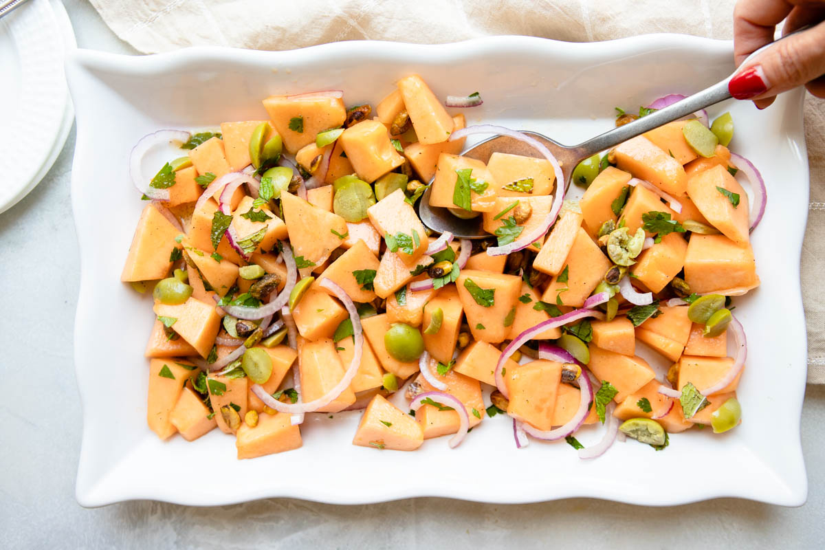 cantaloupe melon salad served on a white platter 
