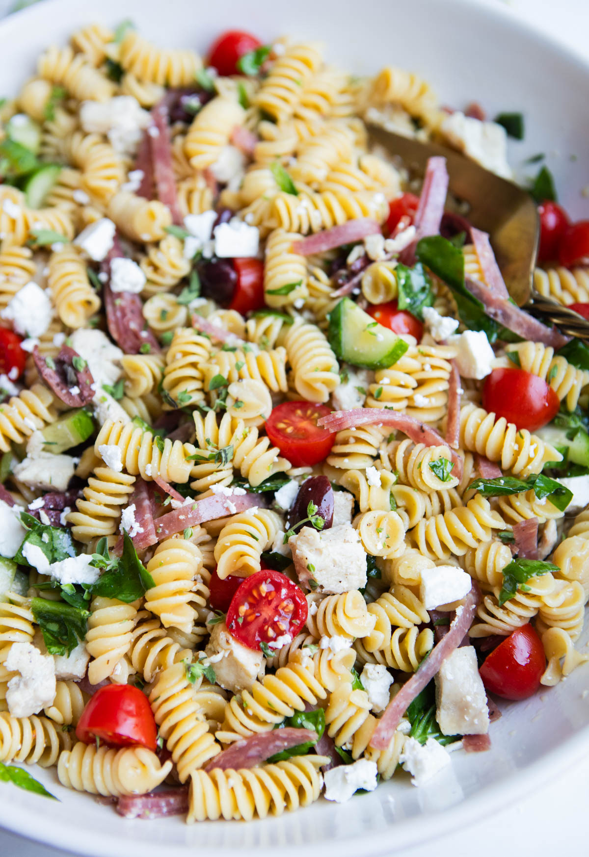 chicken protein pasta salad with veggies in a white ceramic serving bowl 