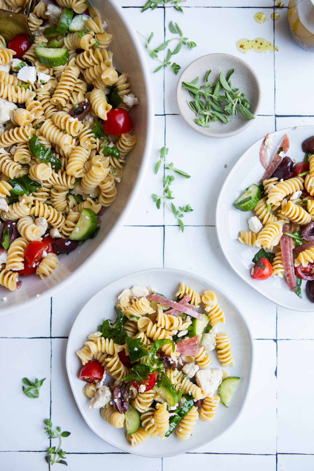 2 small plates filled with Barilla protein pasta salad and mixed veggies 