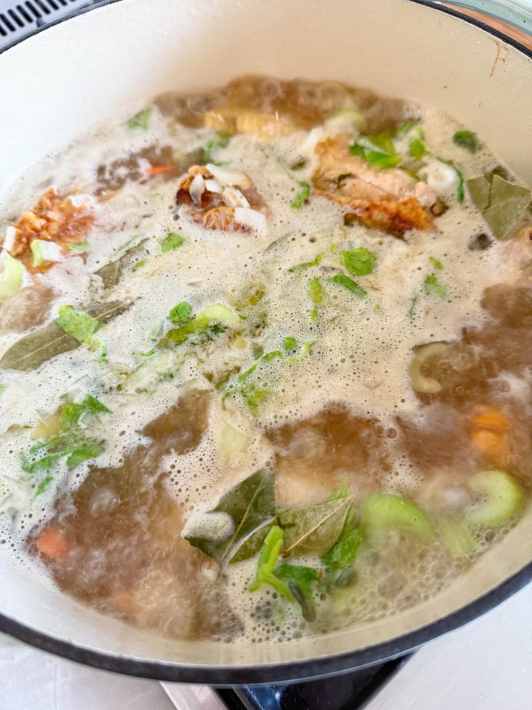chicken stock simmering in a large Dutch oven 