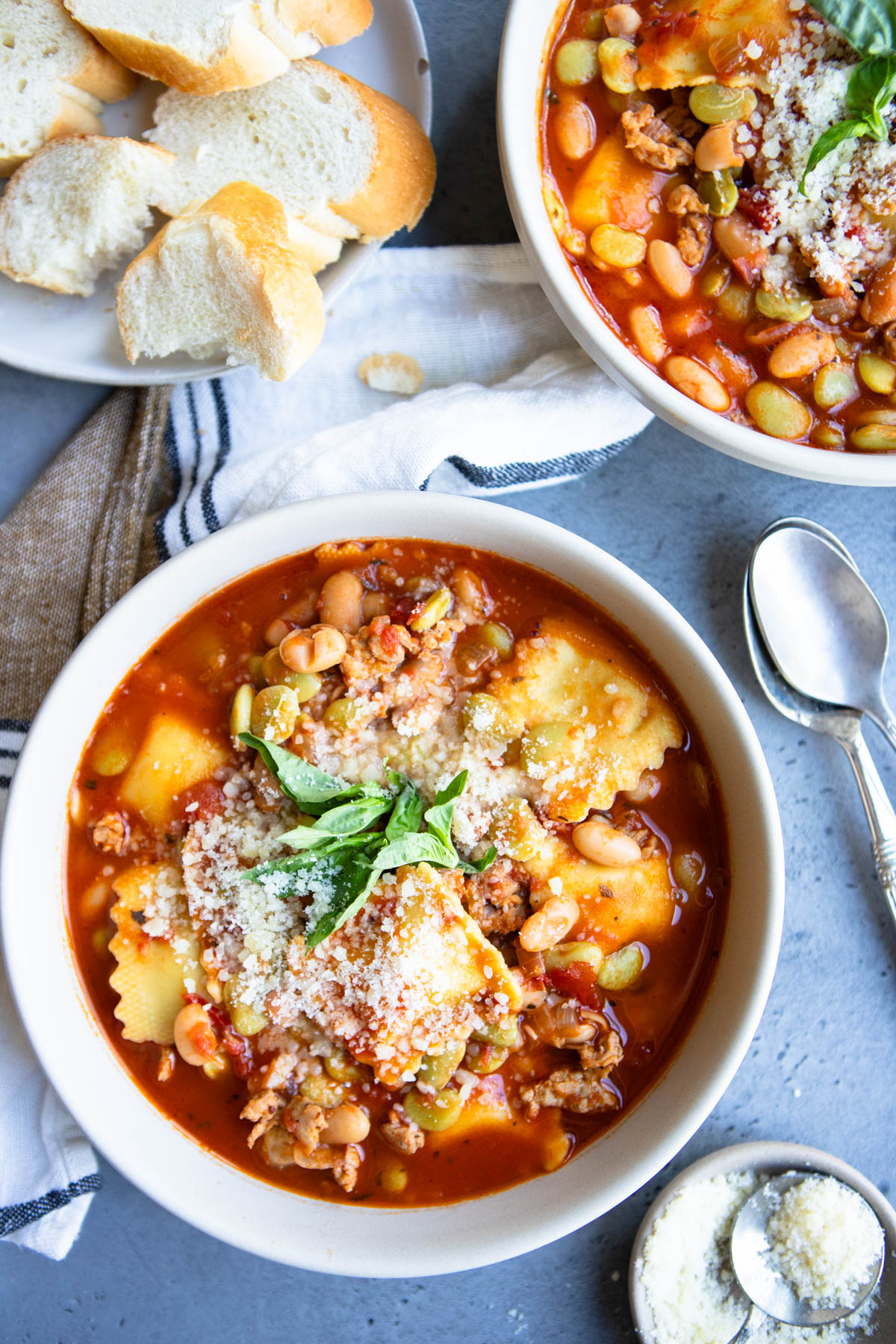 easy pasta fagioli soup in whit bowls garnished with parmesan cheese