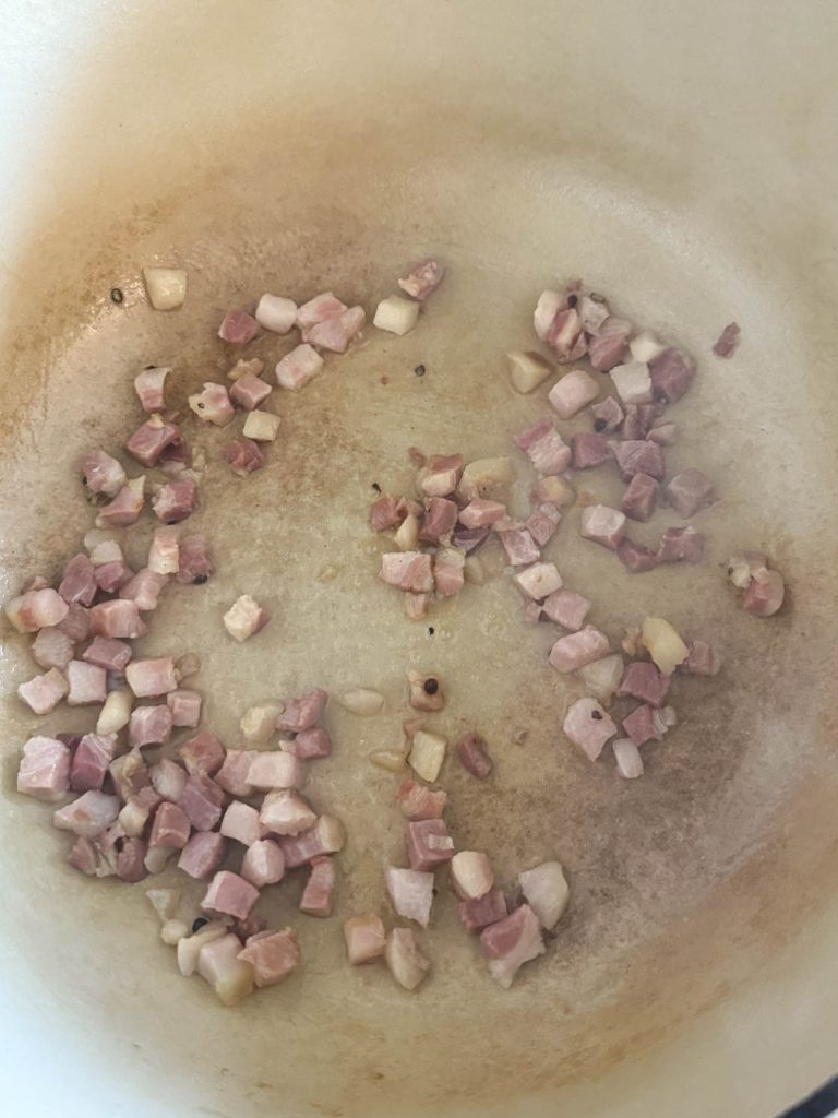 pancetta cooking in a large Dutch oven