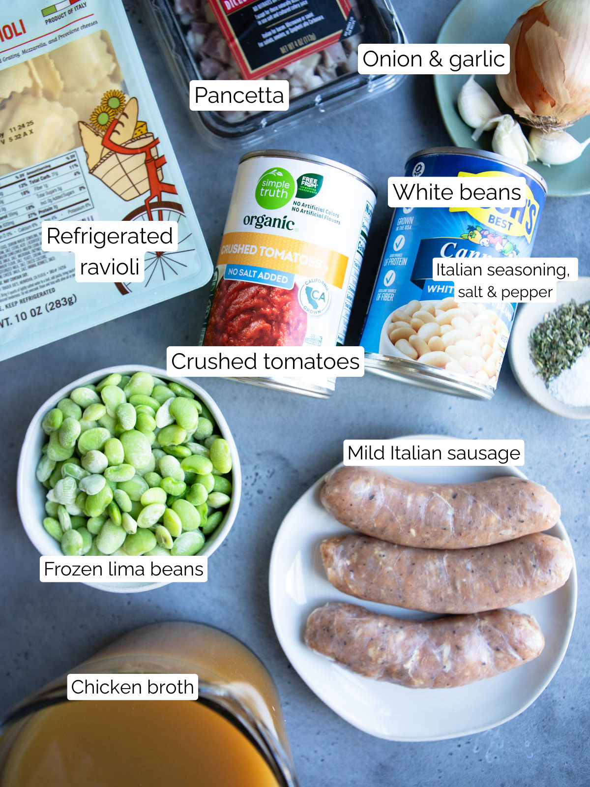 ingredients to make easy pasta fagioli soup on a gray board