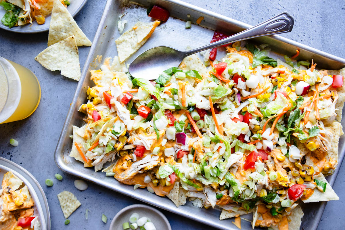 healthy shredded chicken nachos on a sheet pan